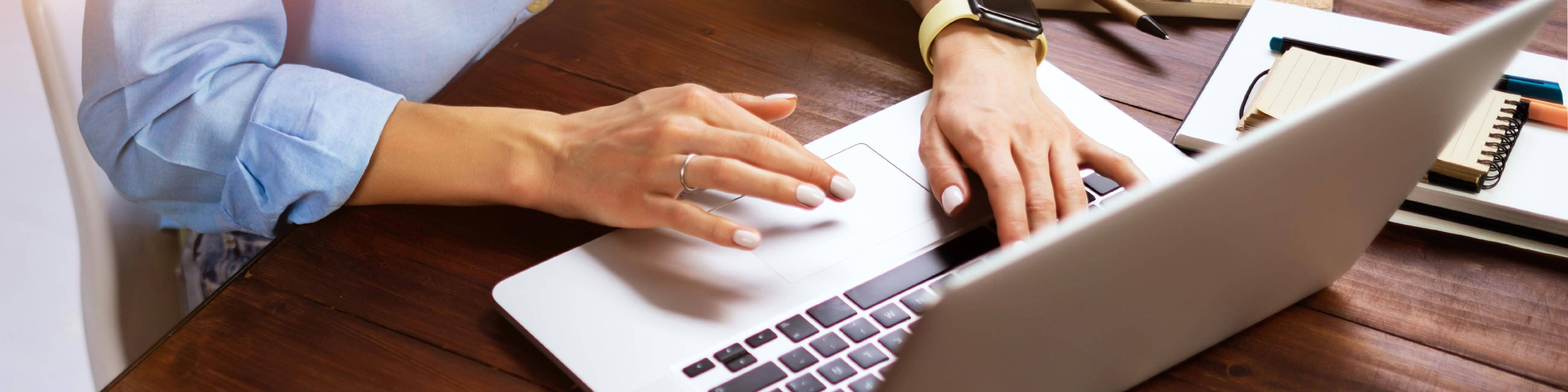 woman typing on a laptop