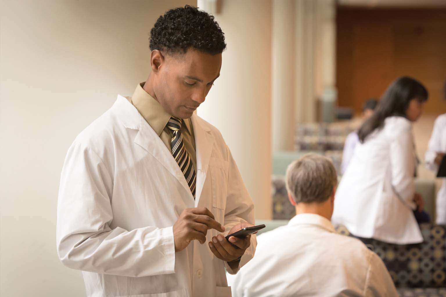 doctor reading information on smartphone