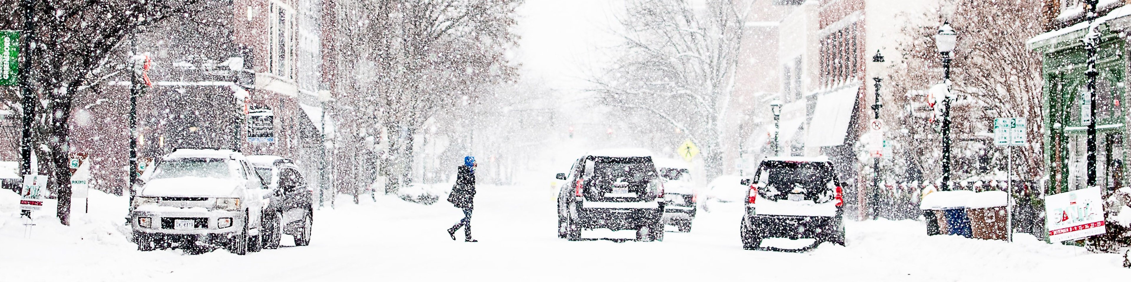 Red traffic light in snow-covered city