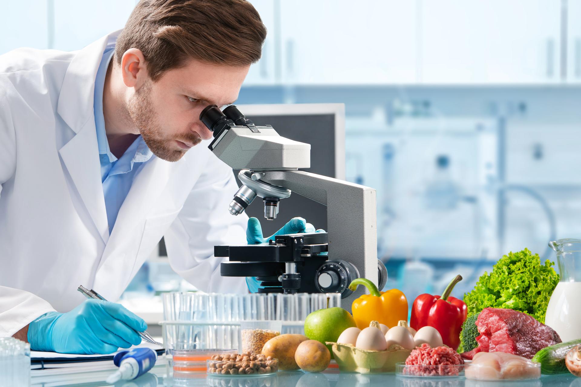 Scientist uses microscope to inspect food samples