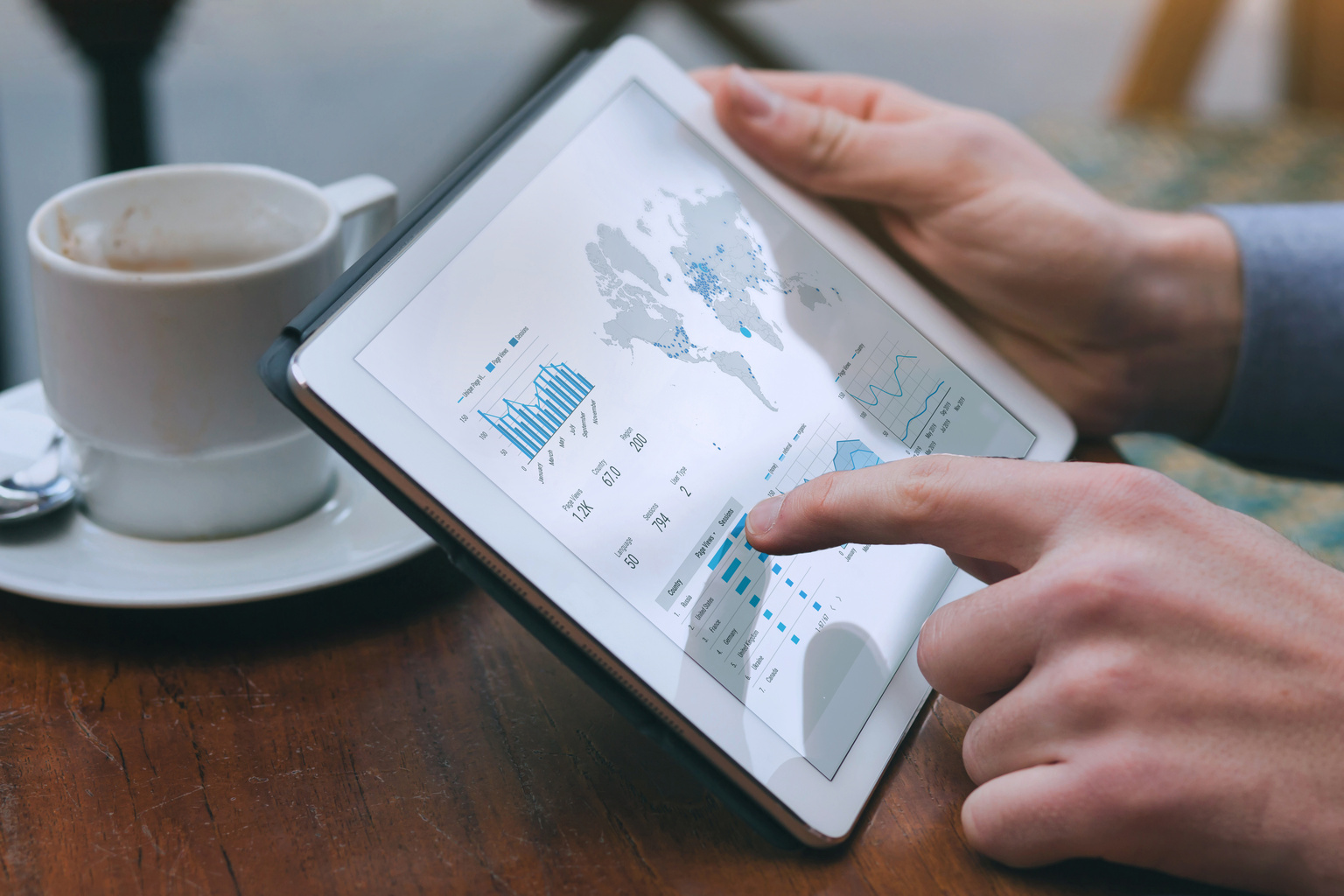 Businessman examining graphs and data on a tablet