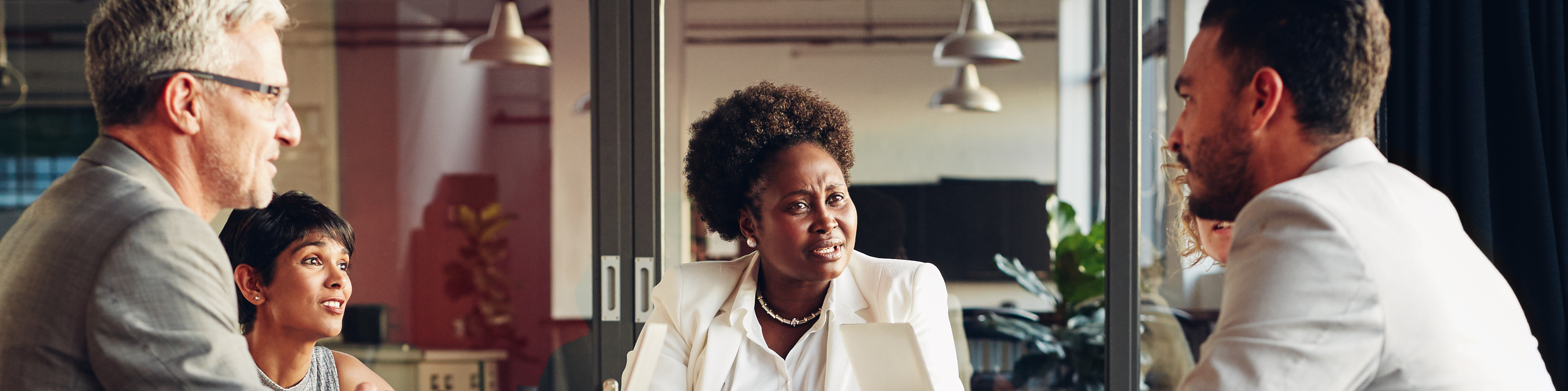 African American businesswoman listening to her team discussing work