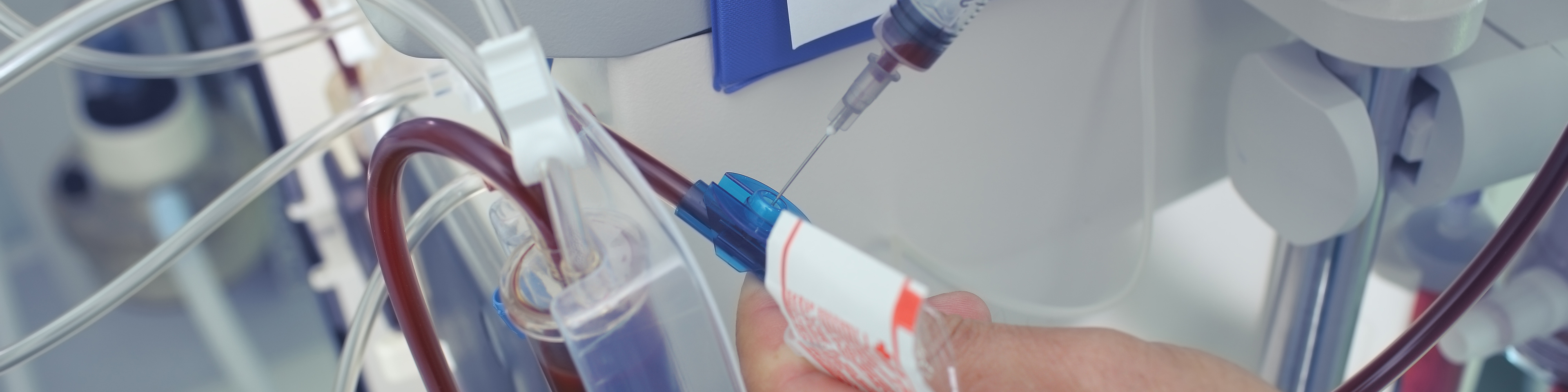 Doctor takes the blood sample from the dialysis tubing