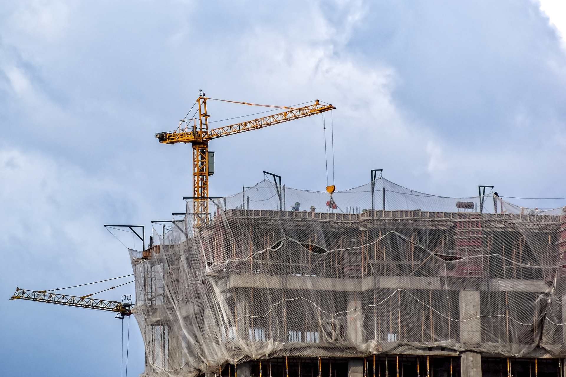 Skyscraper under construction has a crane on top