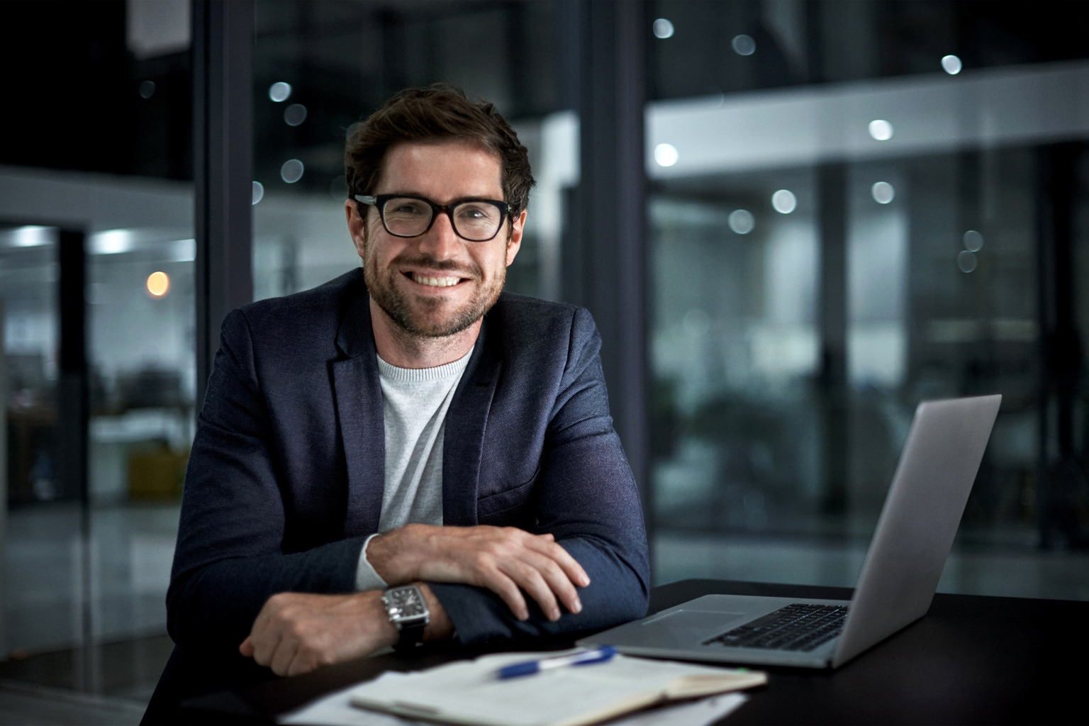 Portrait of a happy young businessman working at his office desk