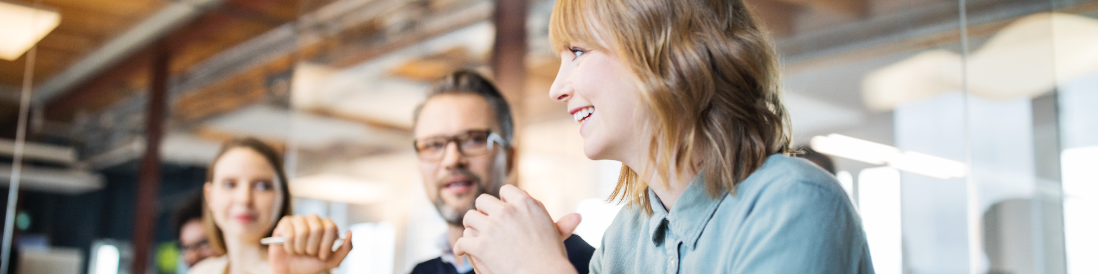 Woman Smiling in a Meeting