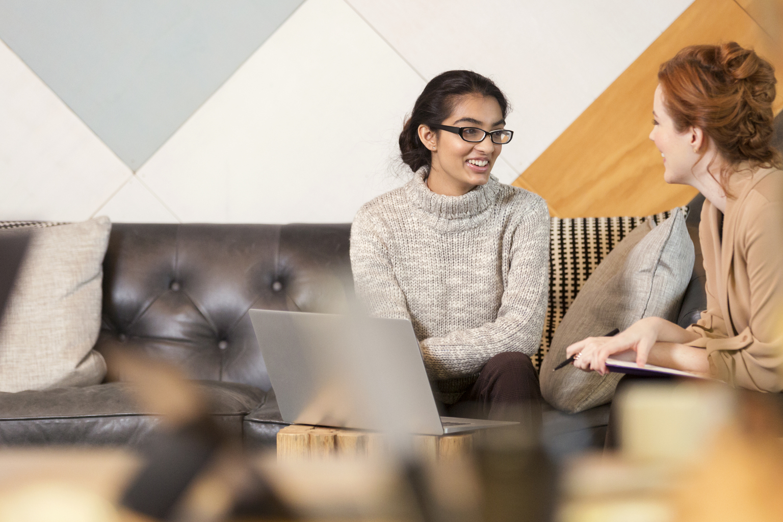 Creative business people having informal meeting in co-working space