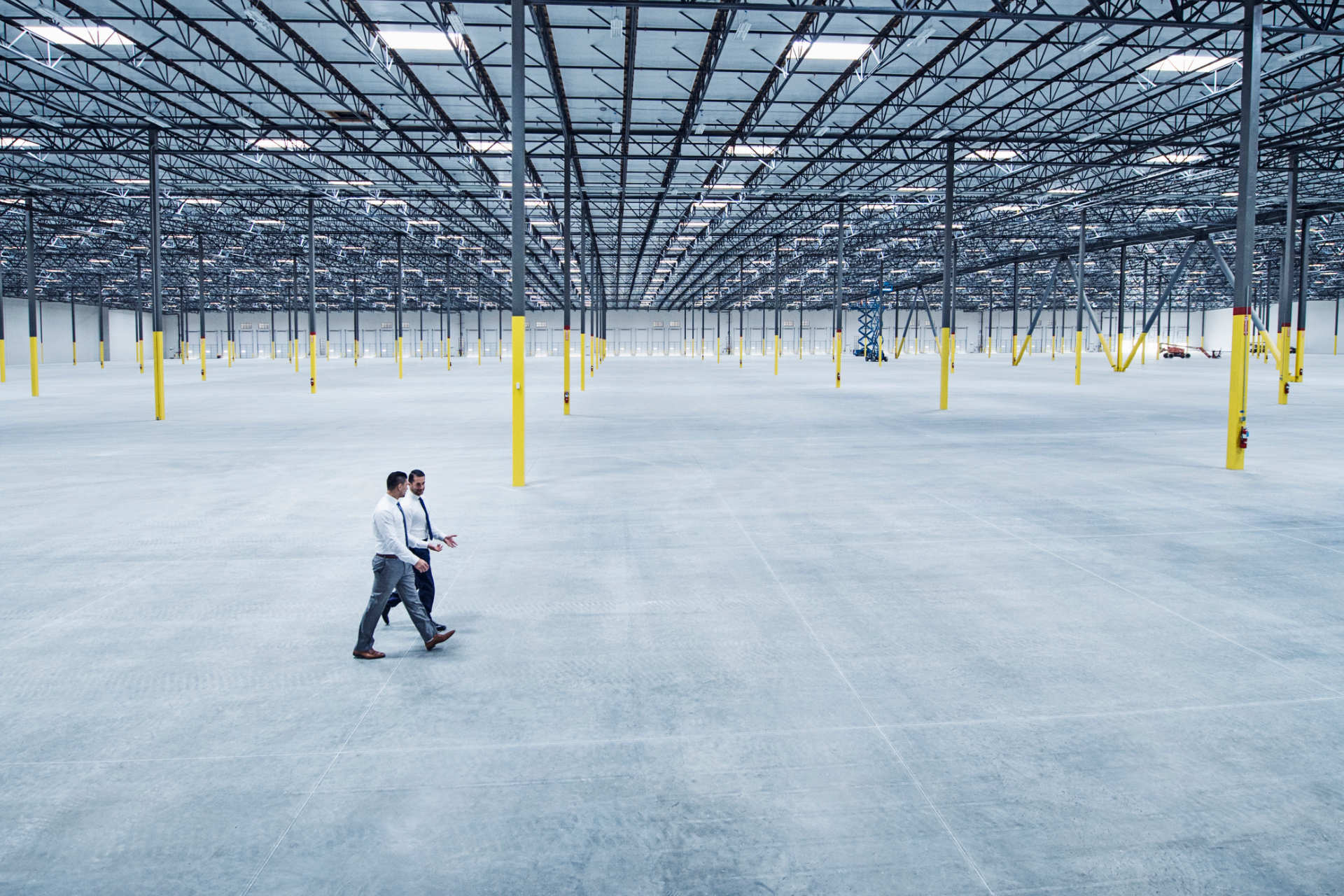 men walk through empty facility