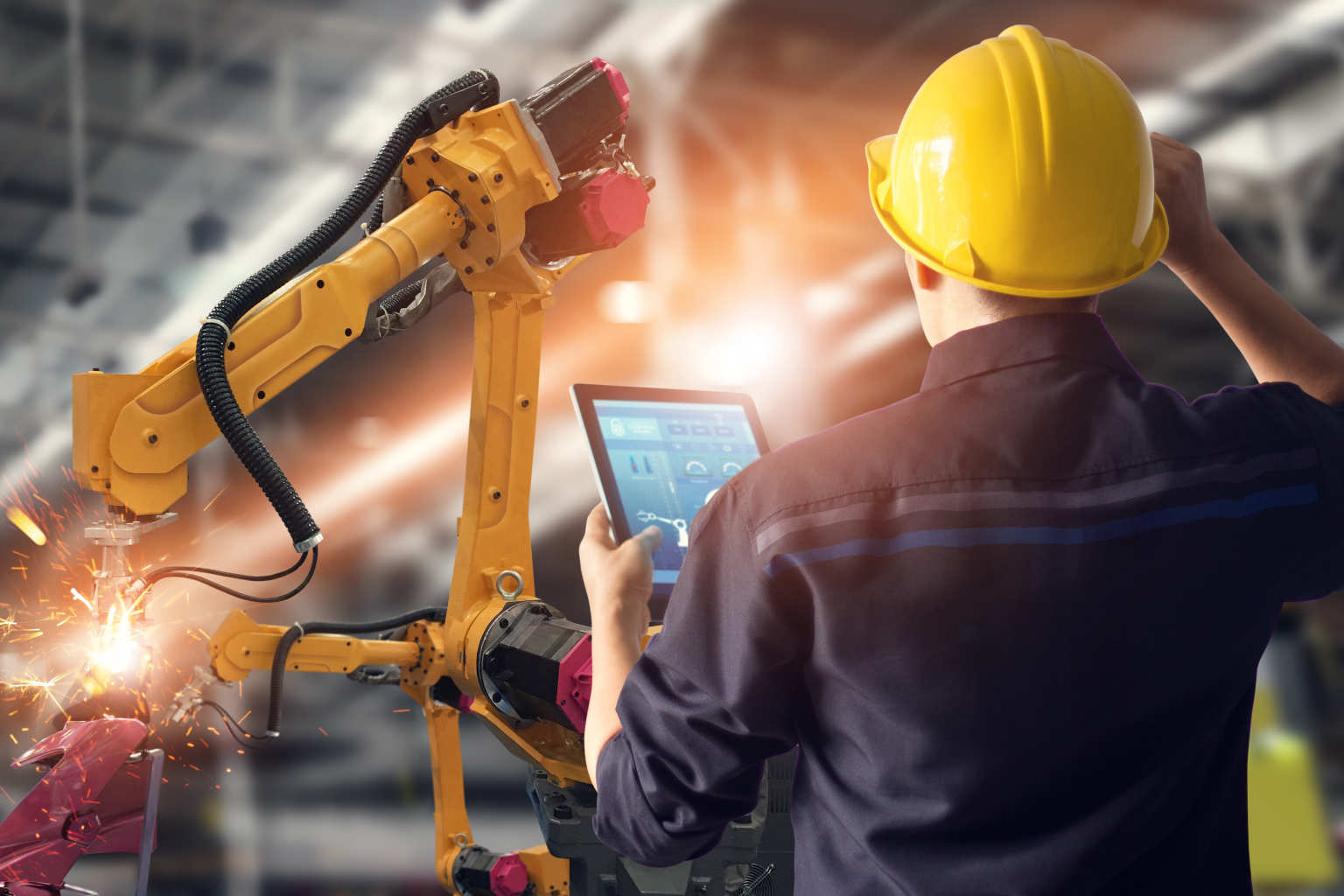 man holds tablet over robot