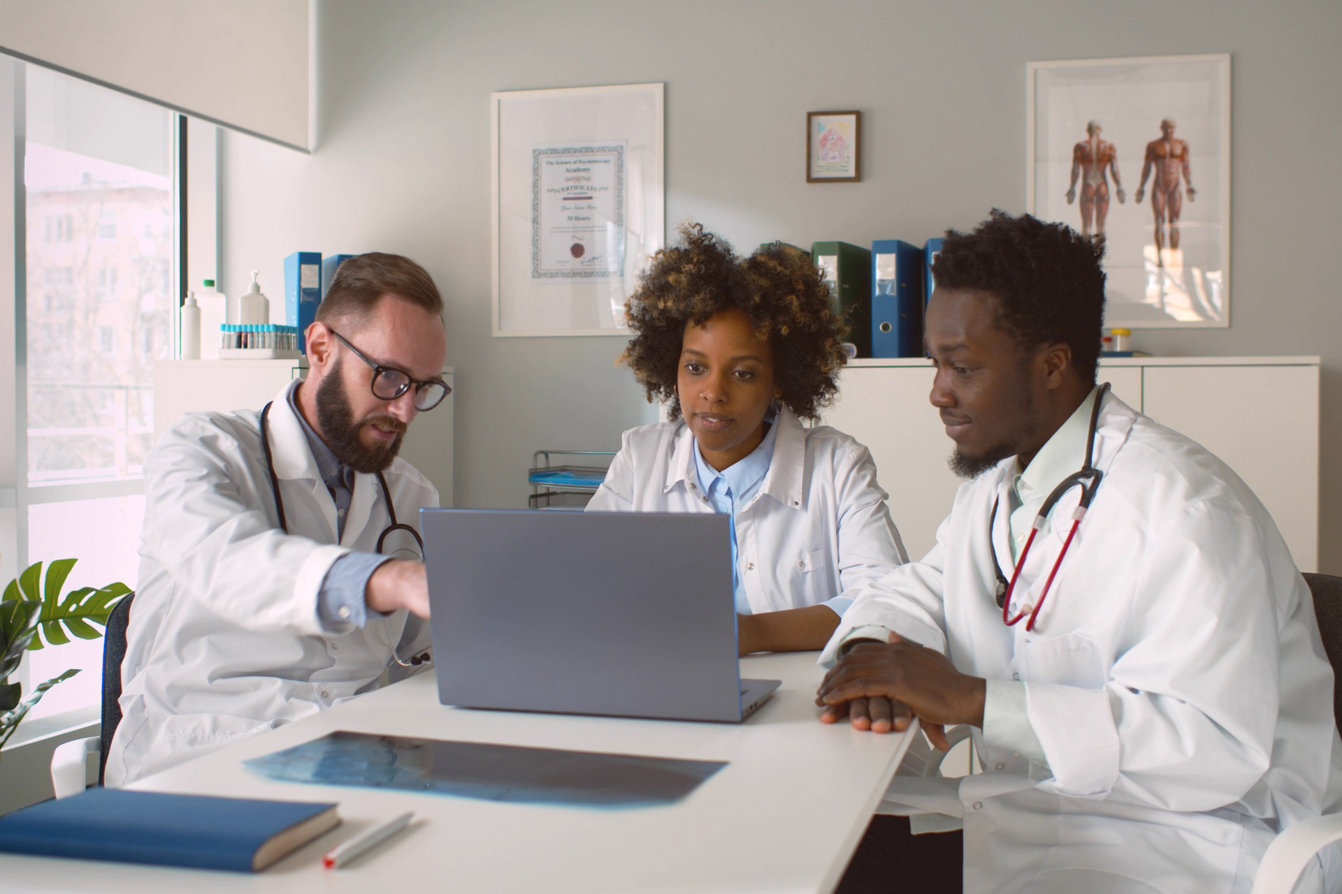 Group of doctors sitting at table discussing treatment options