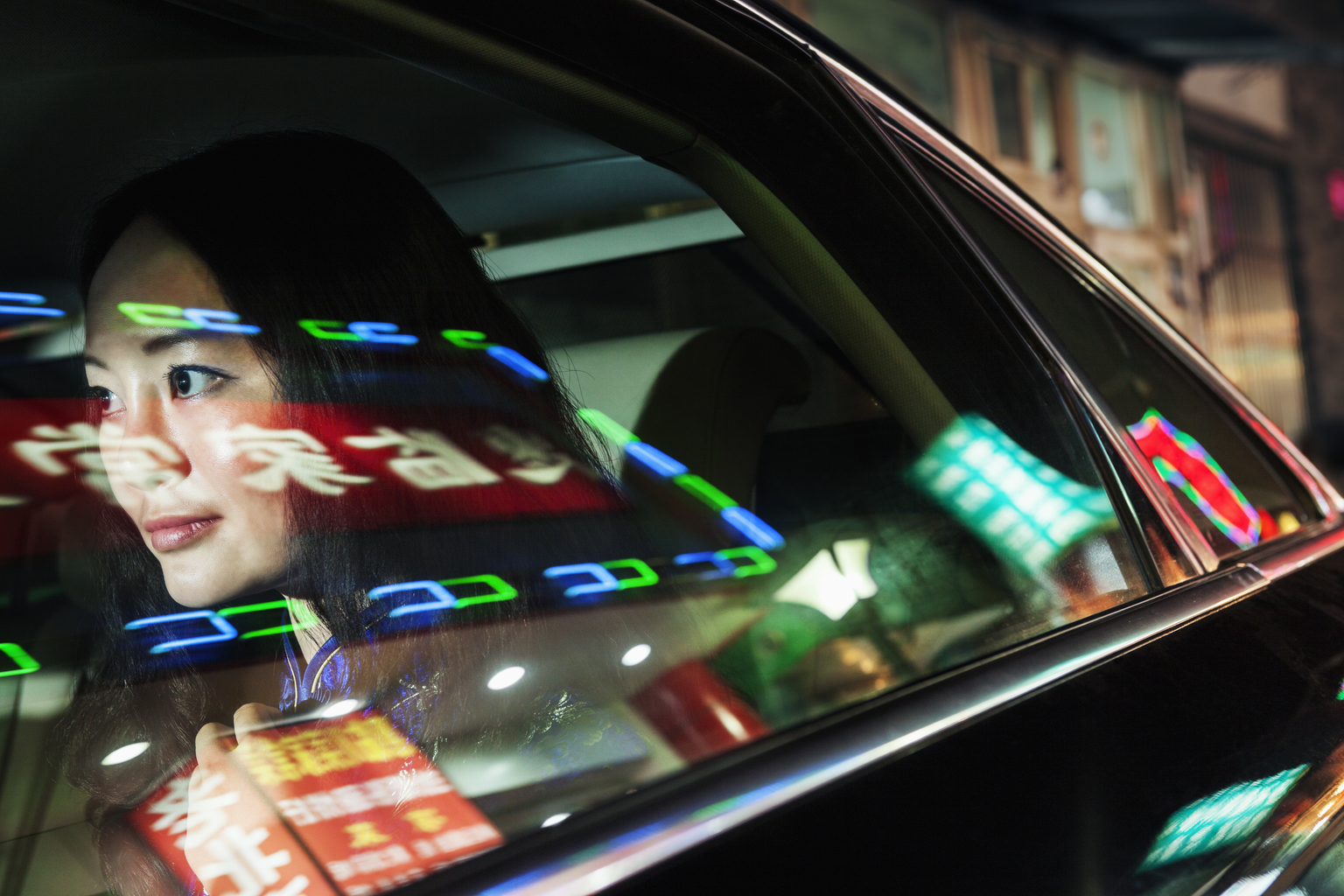 Young Woman In Backseat of Car, Reflected Lights