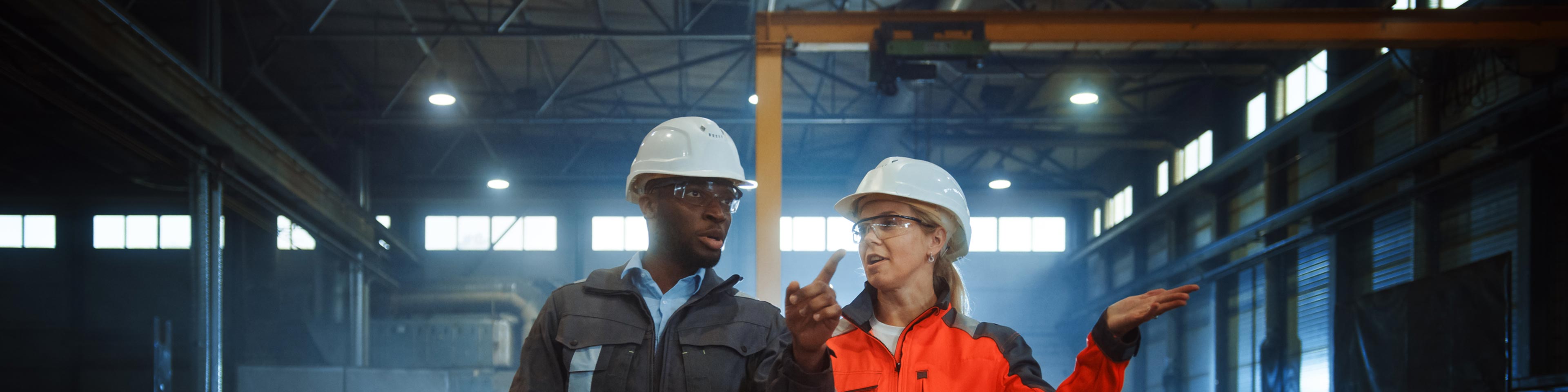 Two construction workers with hard hats