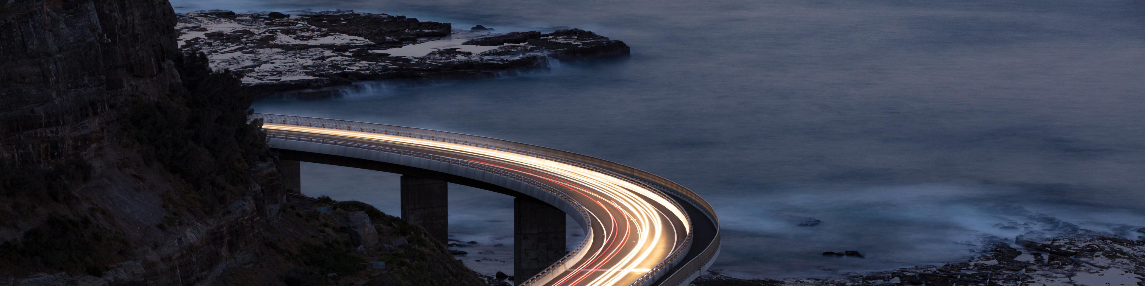 Car light trails on Sea Cliff Bridge, a balanced cantilever bridge located south of Sydney, New South Wales, Australia