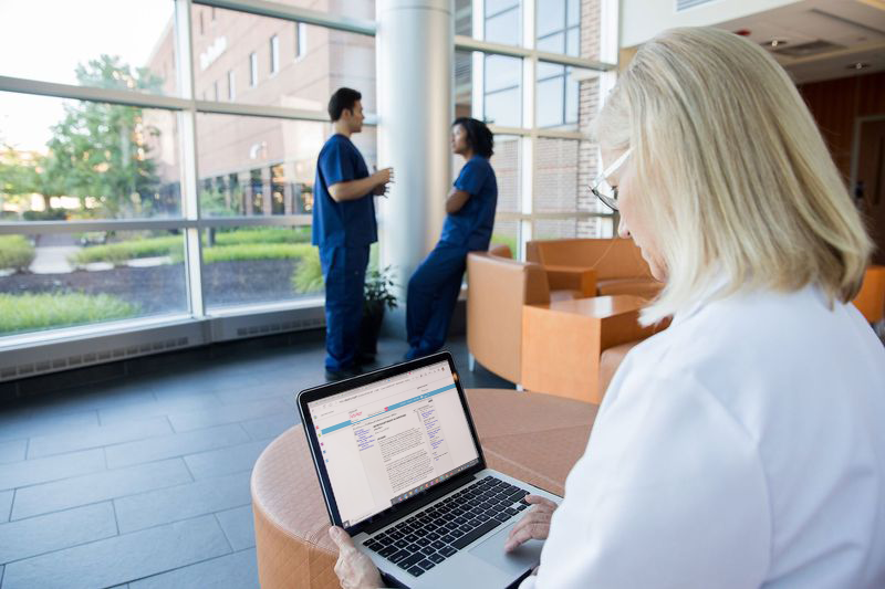 Hospital administrator working on laptop in hospital