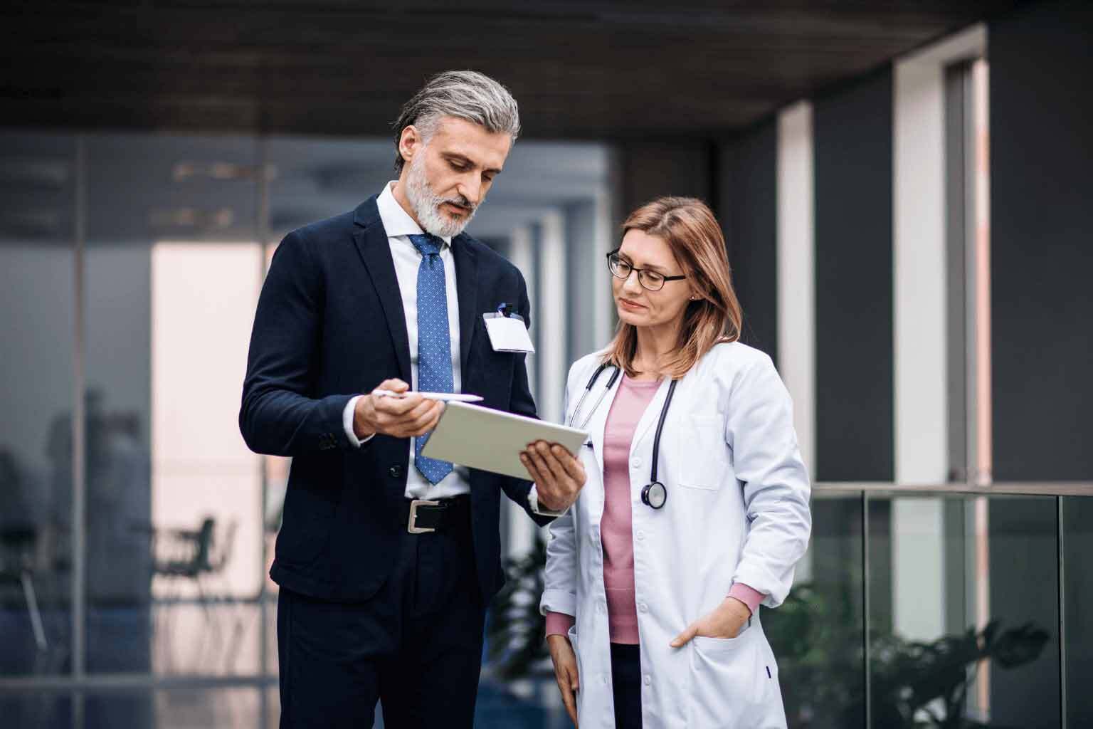 Female-doctor-shaking-hands-with-businessmanjpg