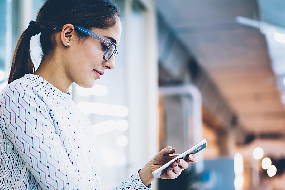 Business woman holding smart phone