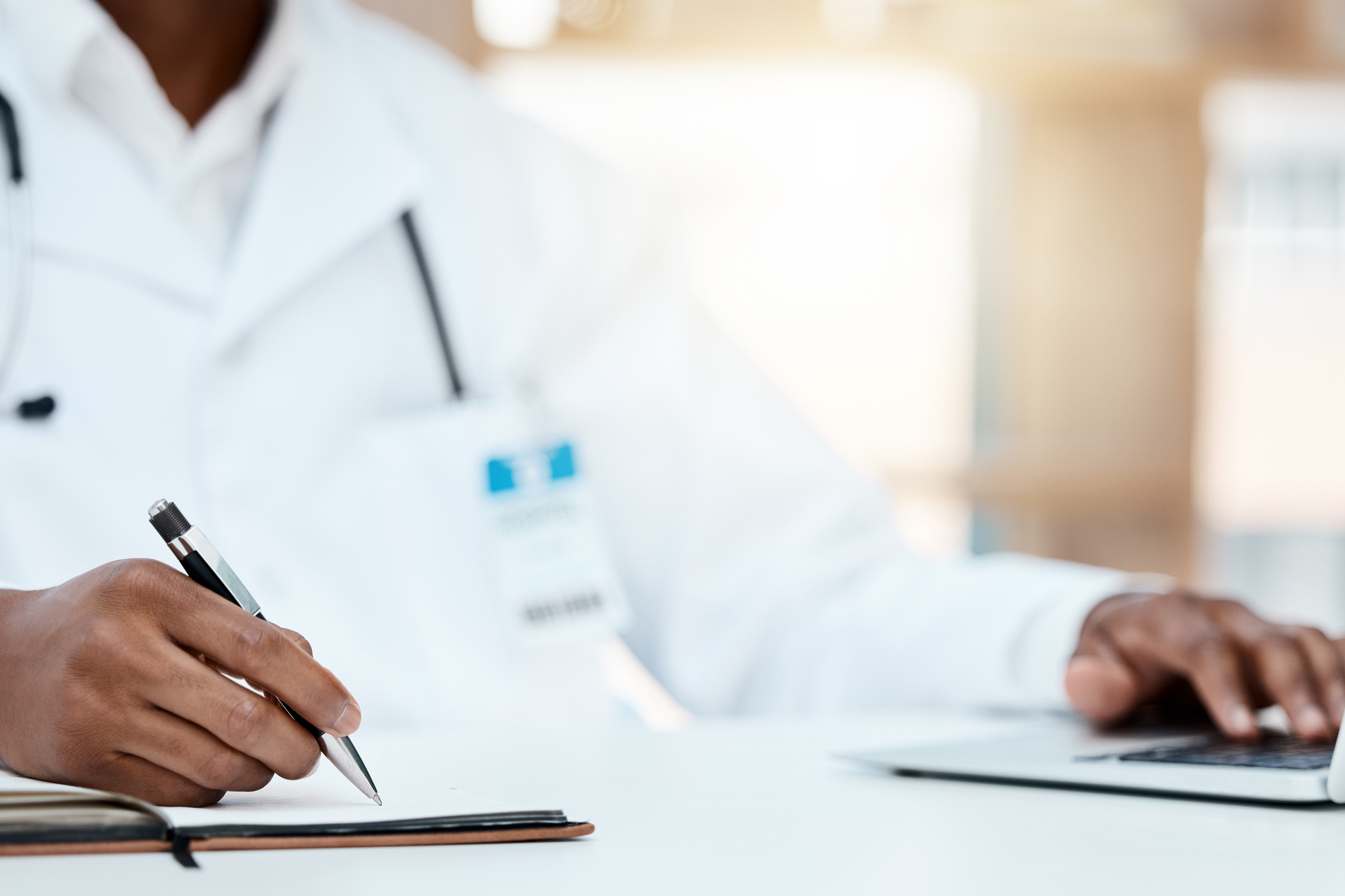 Medical professional typing on laptop