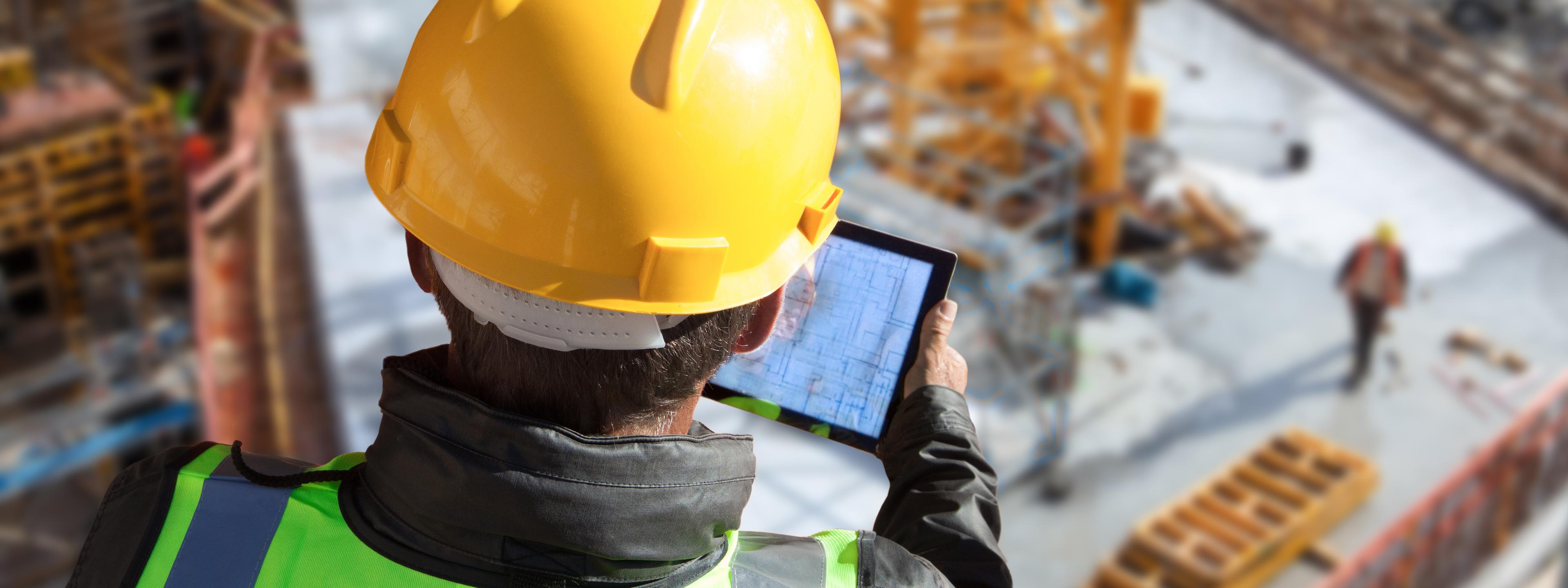architect engineer construction worker with hard hat working on site with tablet computer