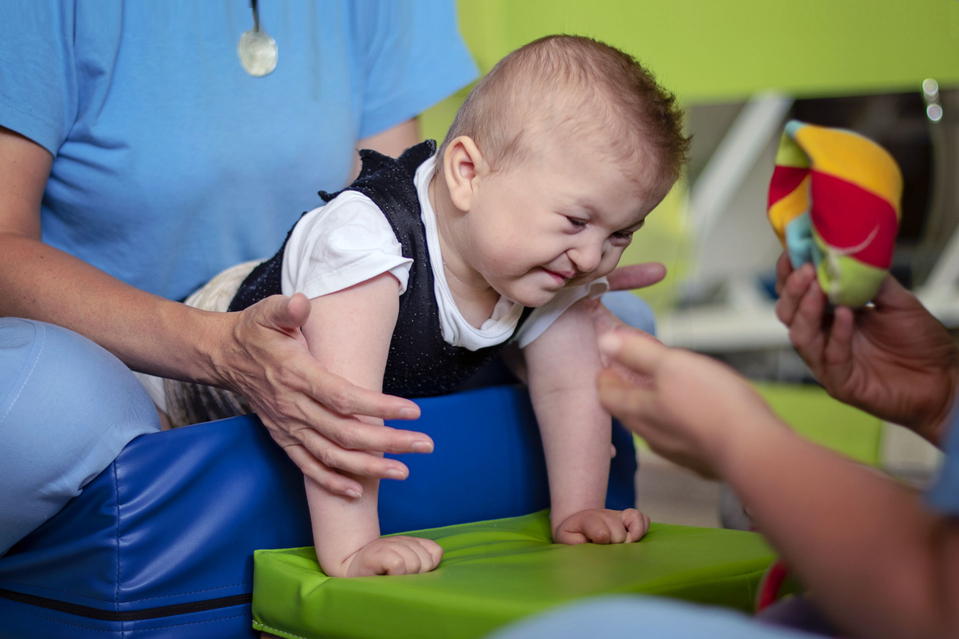Portrait of a baby with cerebral palsy on physiotherapy in a children therapy center