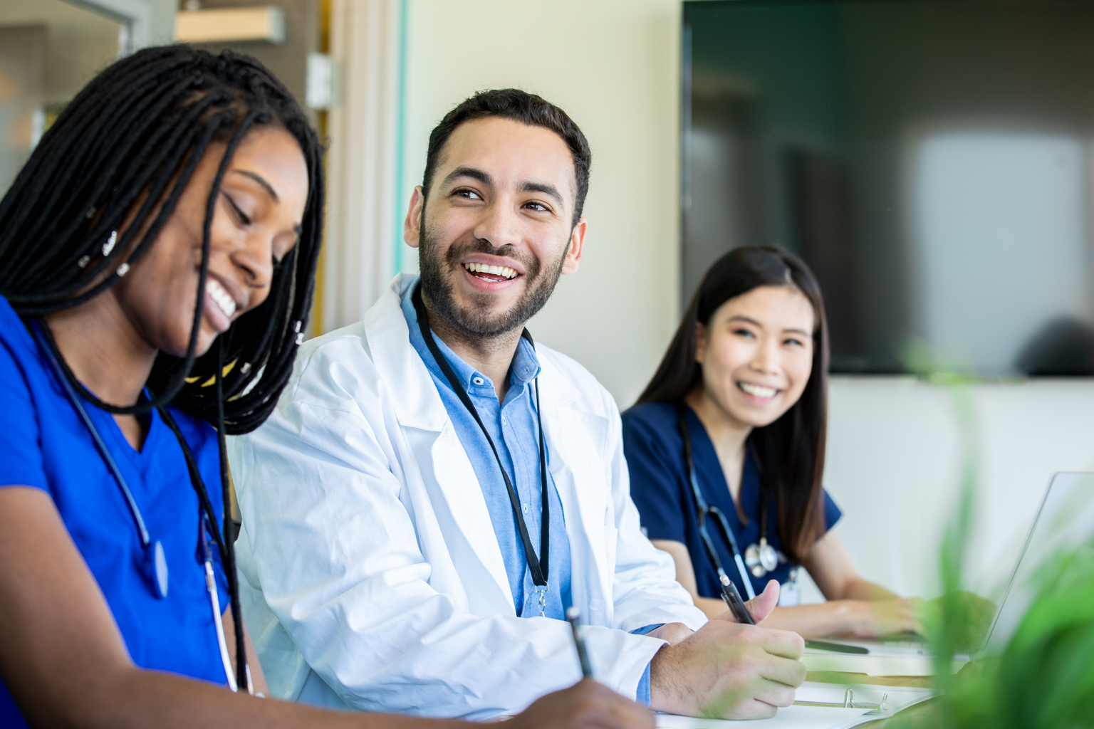 Medical students smile during meeting in conference room