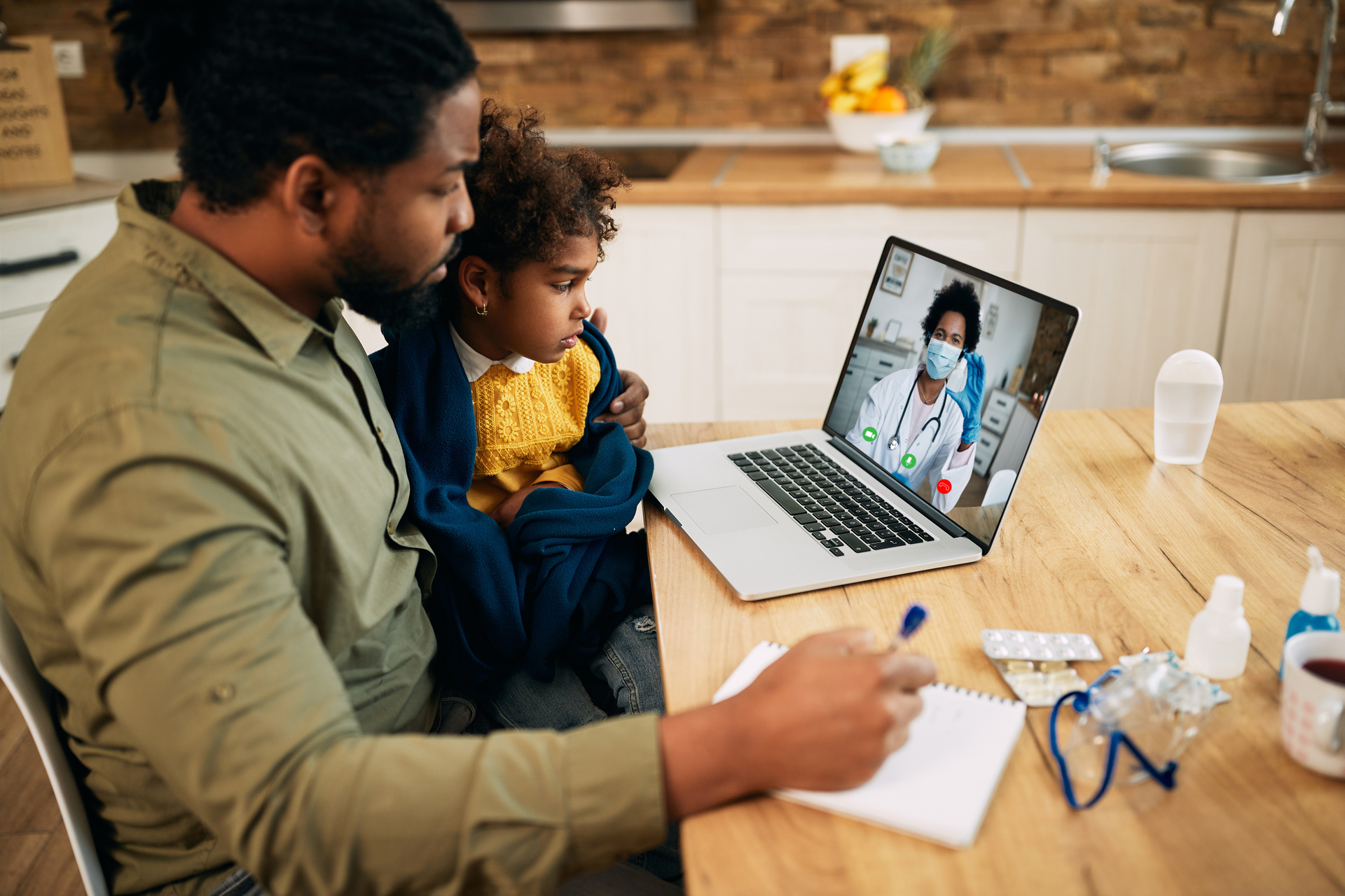 Father on a telemedicine call with child