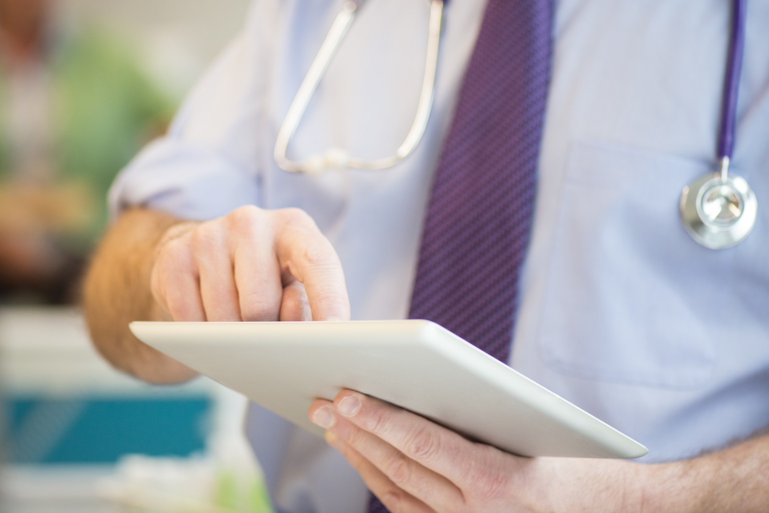 Healthcare worker using tablet to work