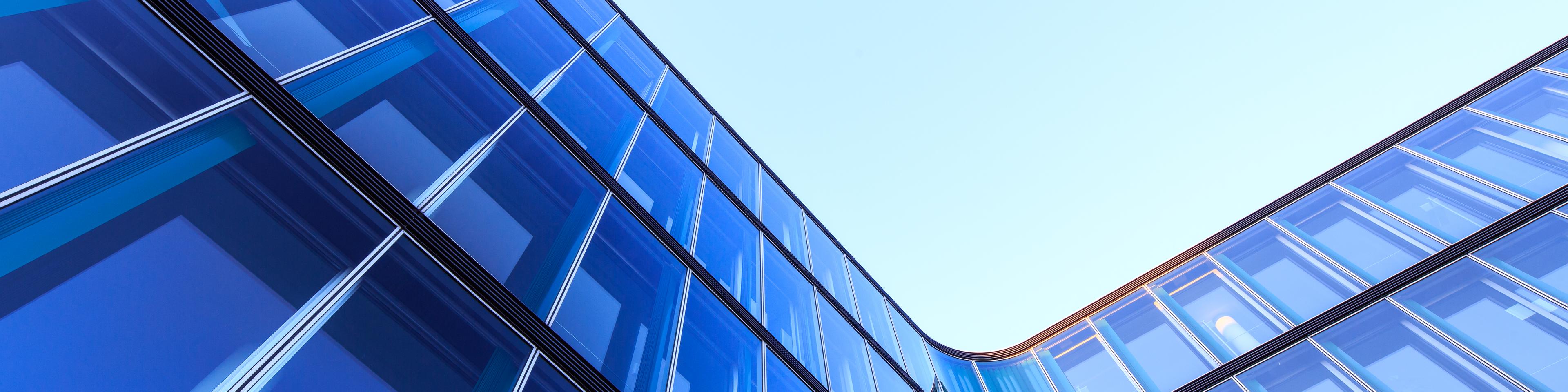 L-shaped glass facade of a modern office building in Hamburg, Germany.