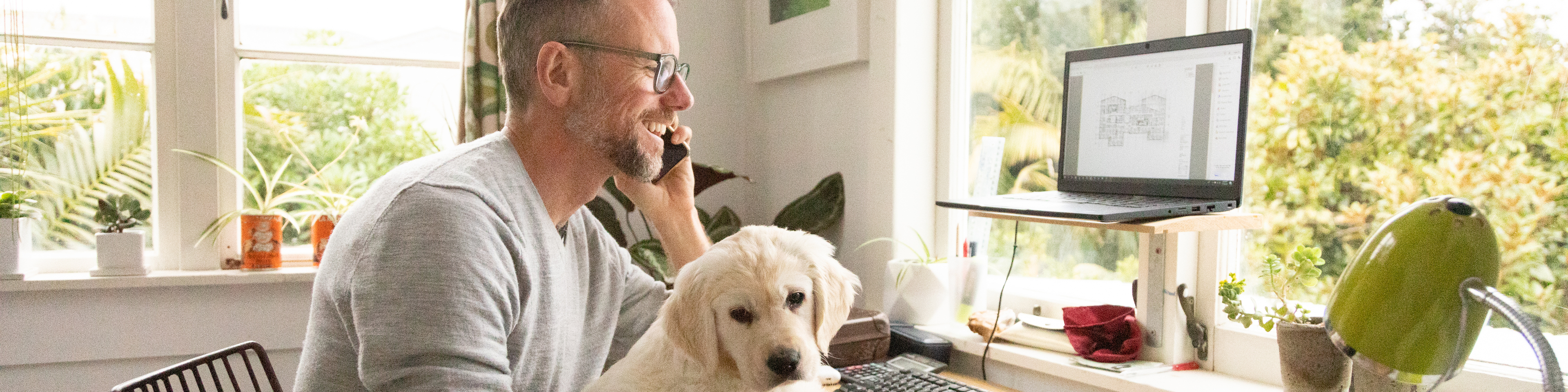 Man Working from Home with a Dog in lap