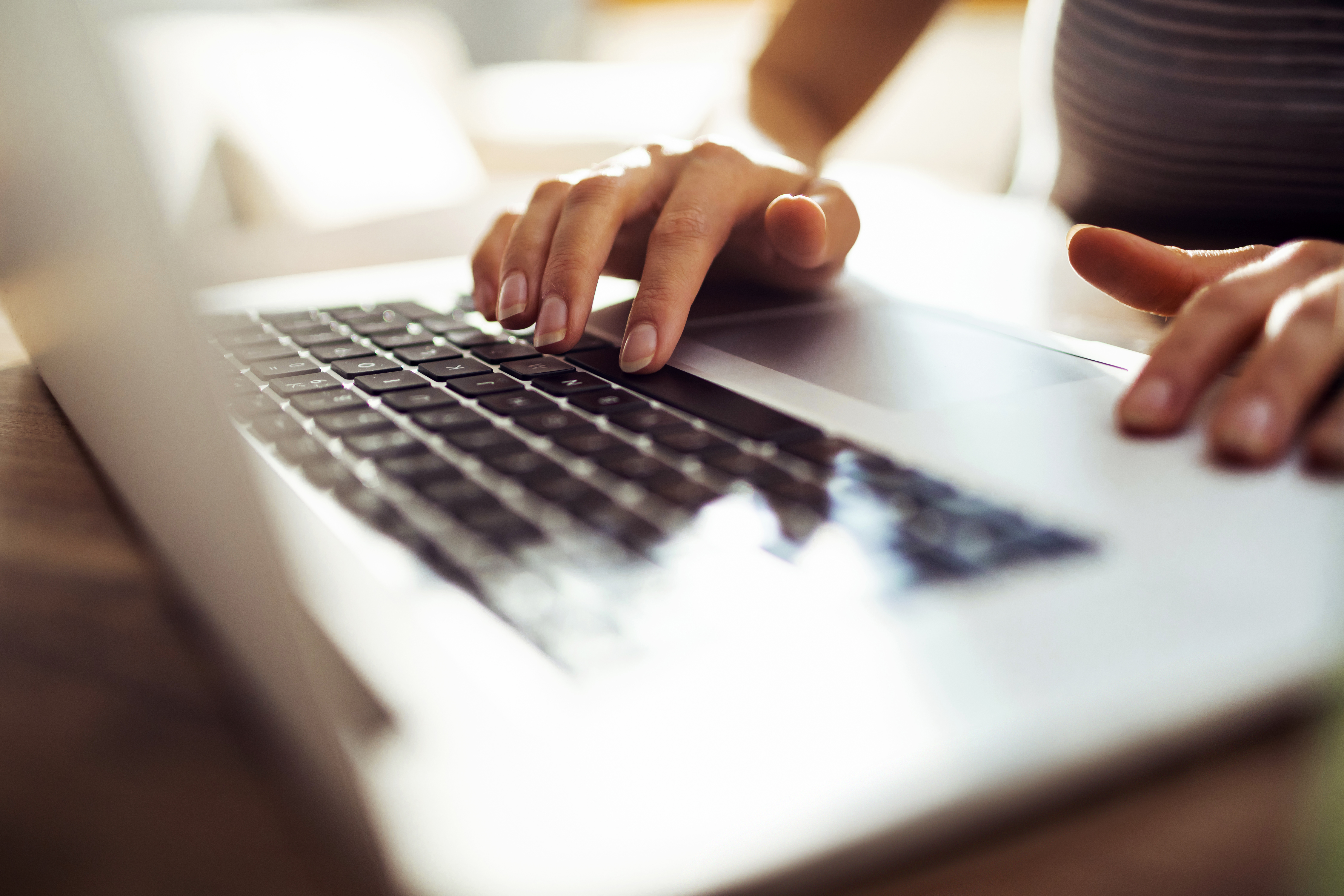 Woman with striped shirt, and long nails using the spacebar button on macbook, close up photography image, Q3 2021, TAA NA US - Preparer