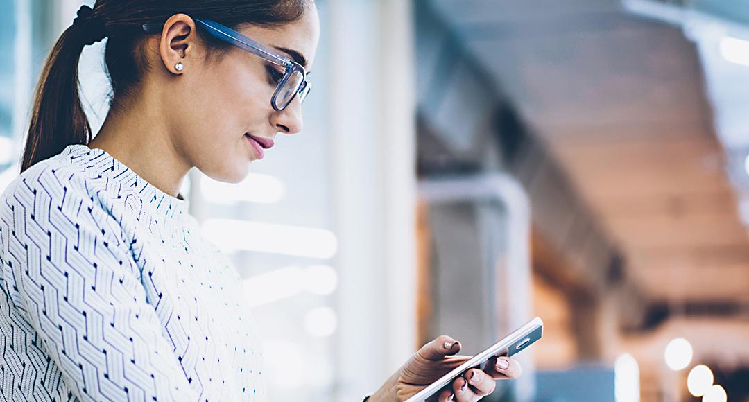 Business woman holding smart phone