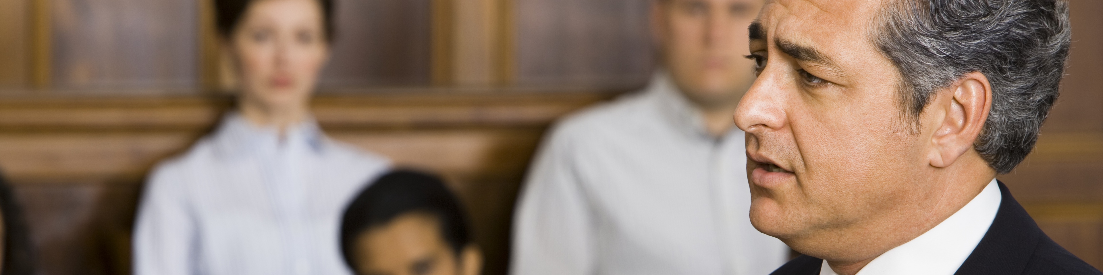 A male lawyer talking in a courtroom