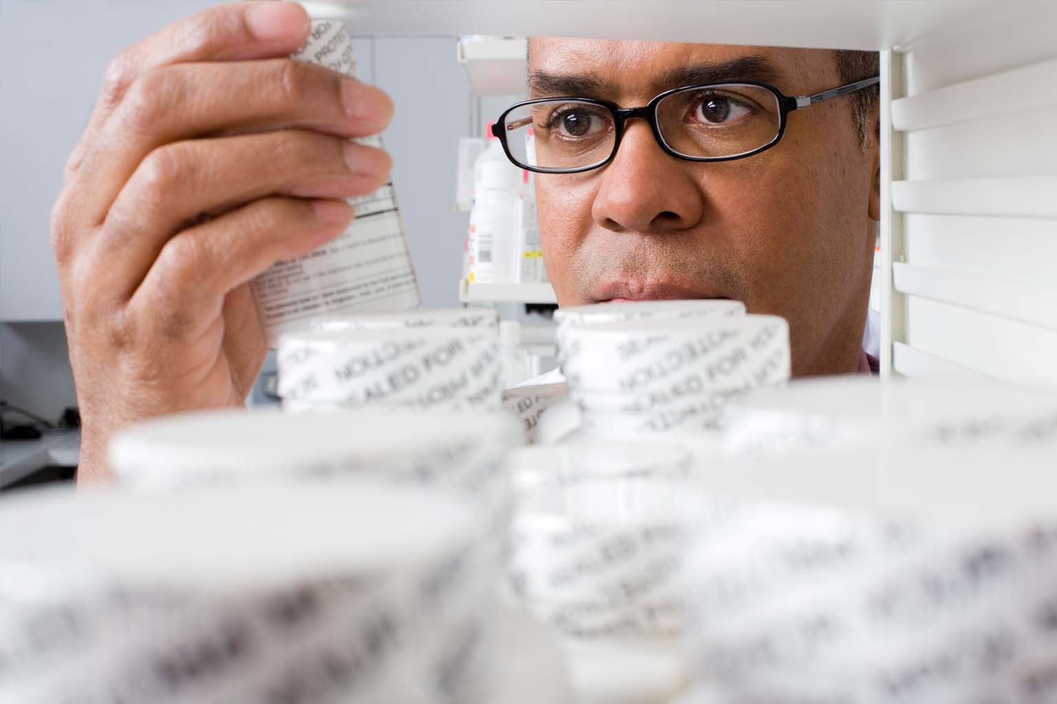 phamacist holding bottle of pills