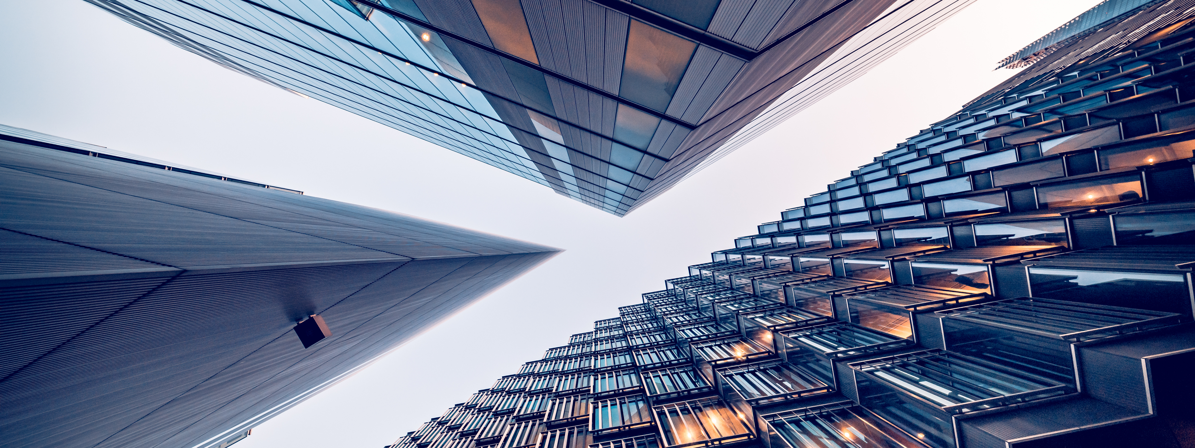 Looking directly up at the skyline of the financial district in central London