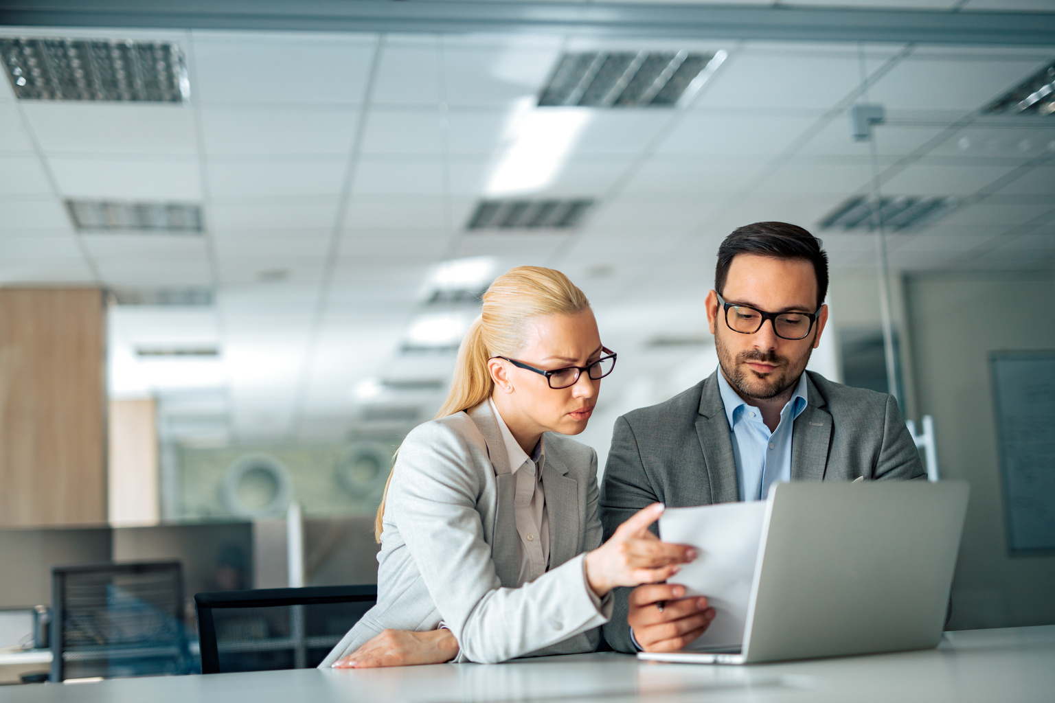 Two business executive looking at business report