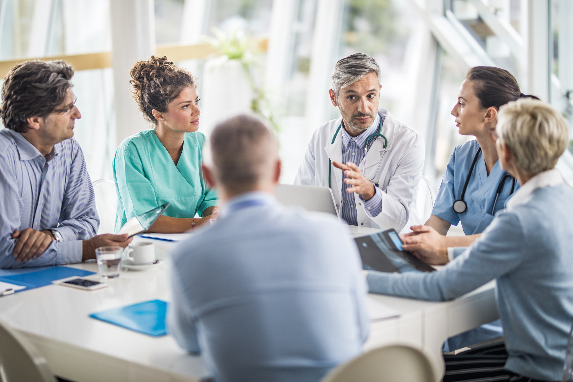 Team of doctors and business people in a meeting.