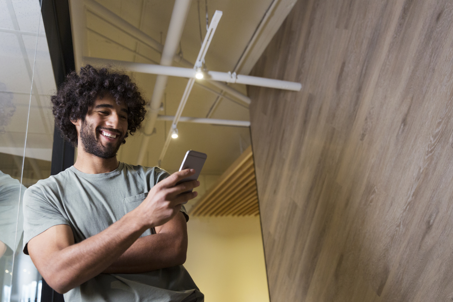 Creative businessman using cell phone in modern office