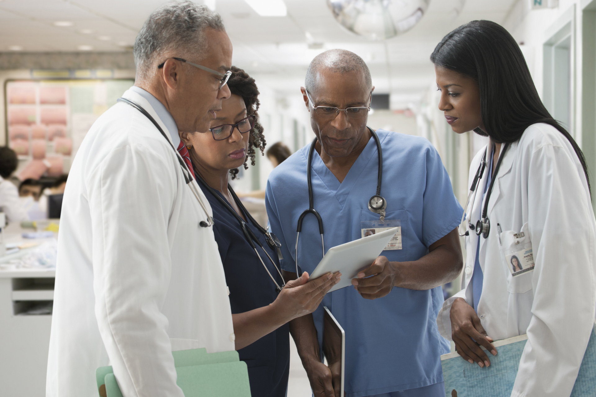 Doctors and nurses reviewing medical chart in hospital