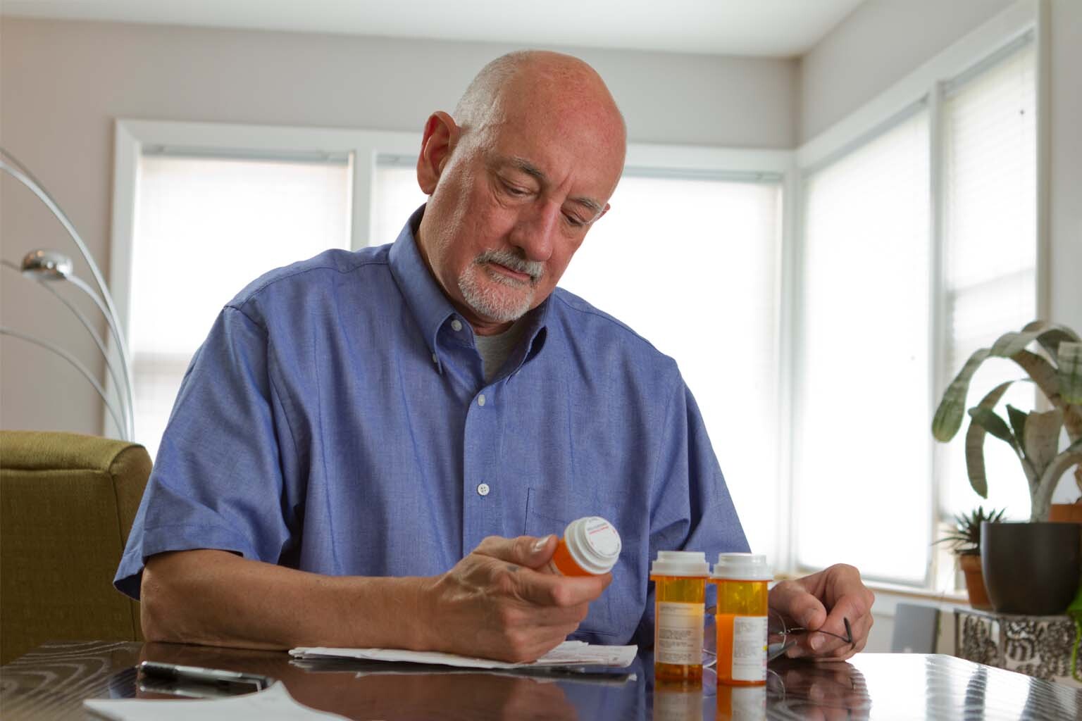 man reading label on prescription bottle