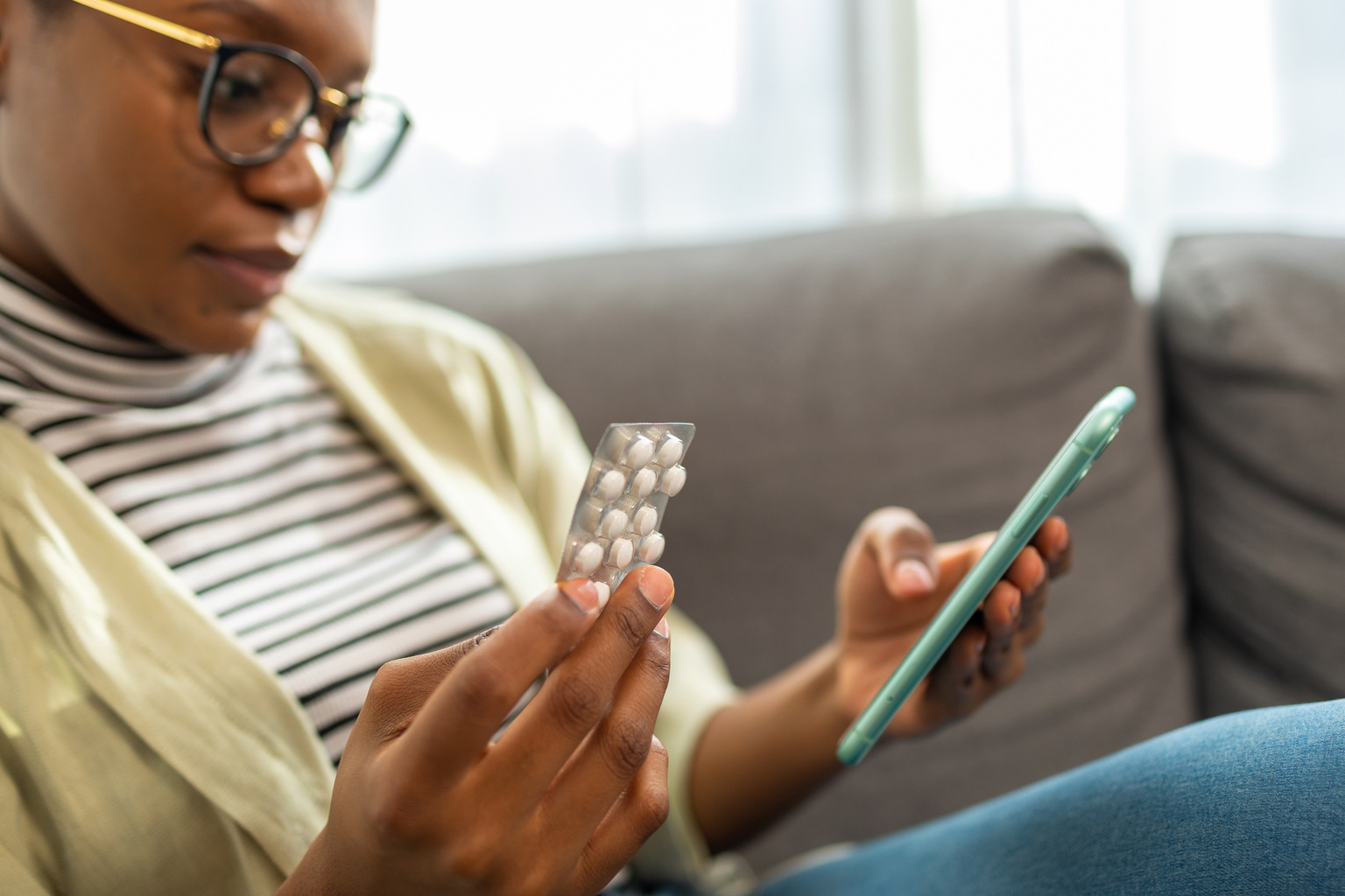 Portrait-female-patient-medication-pills-drugs-smartphone-mobile-Adobe-536167177