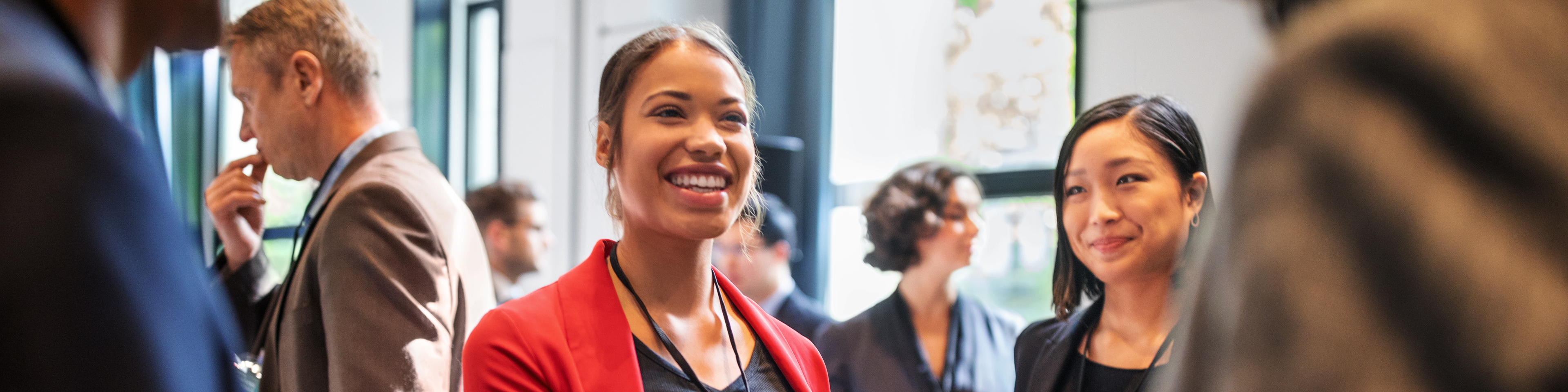 Businesswomen handshaking in auditorium corridor 