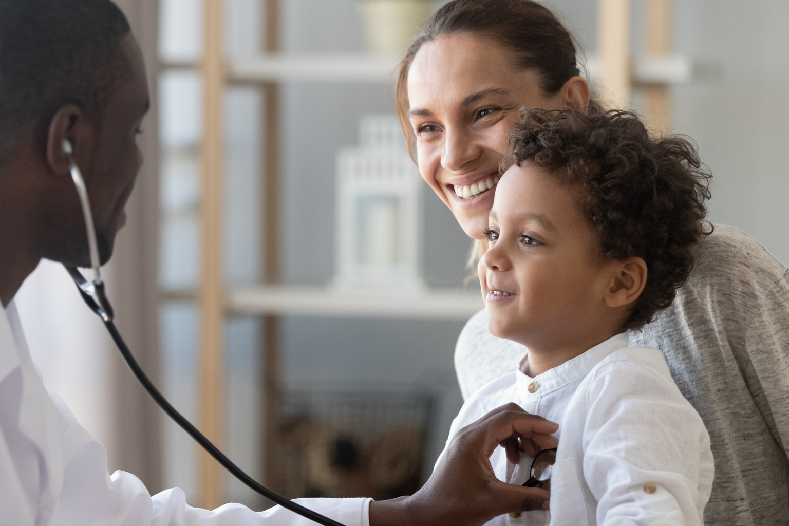 African male pediatrician hold stethoscope exam child boy patient