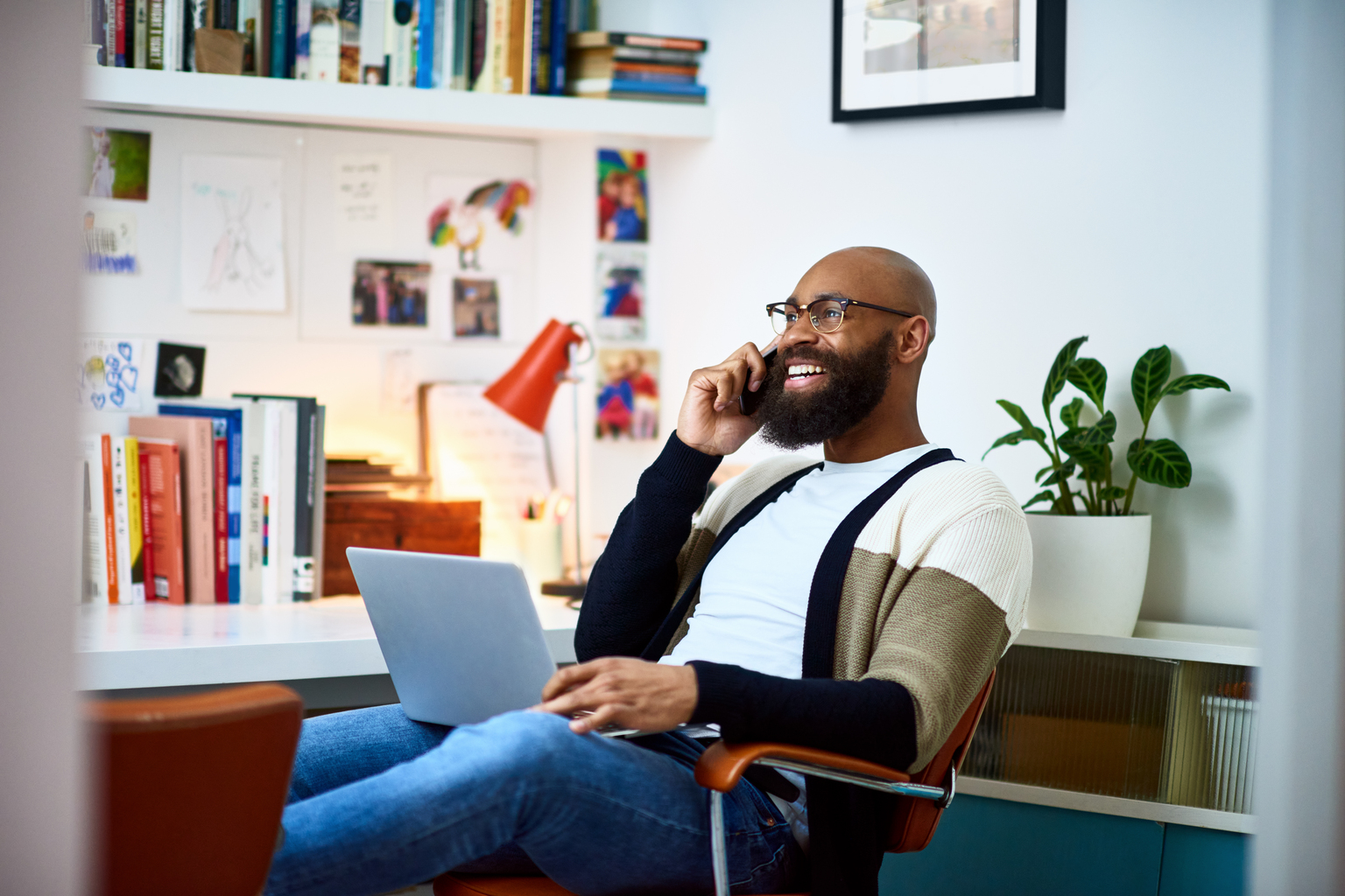 An African American employee working from his home office