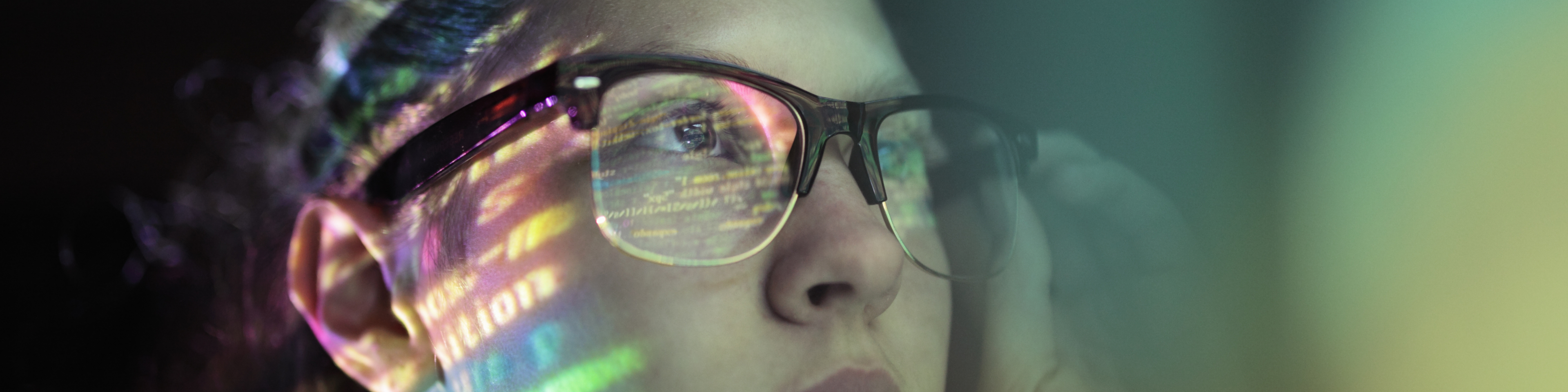 woman with brown glasses staring at code screen with the reflection hitting her glasses, Q3 2021, TAA NA US - Preparer
