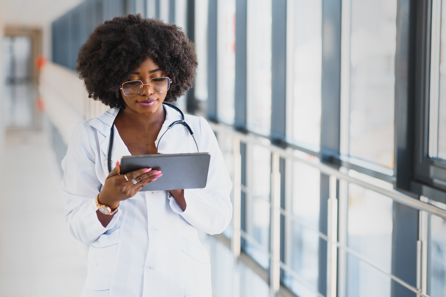 Doctor walking down hall with tablet