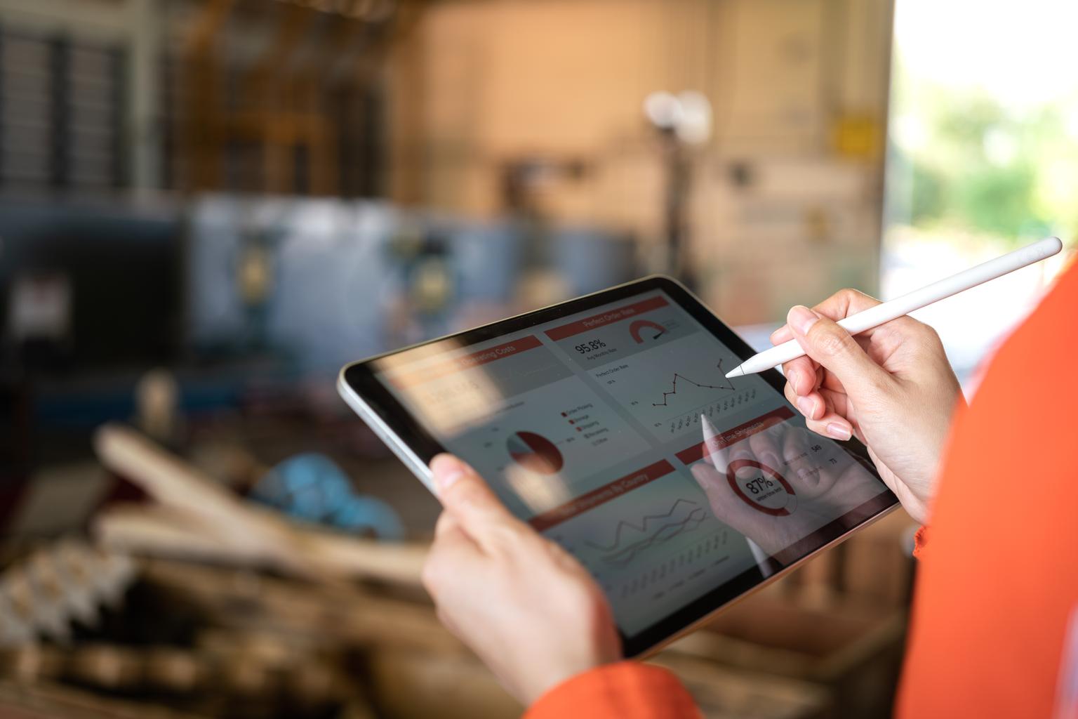 worker using tablet to review report data