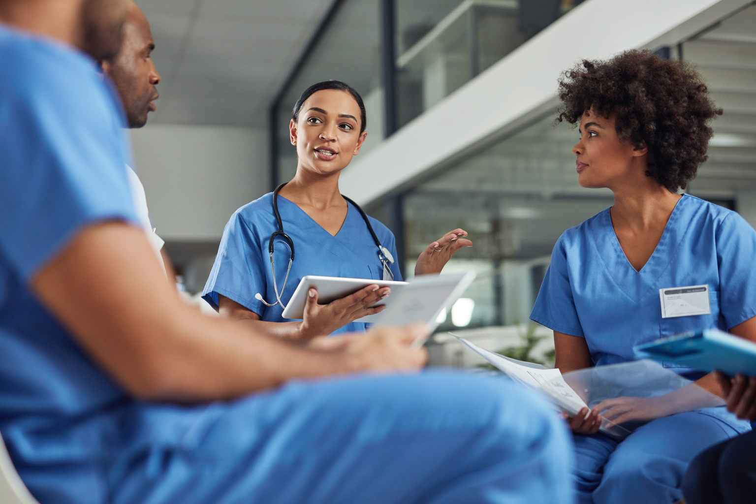 Deciding on a course of treatment for their patients. Shot of a group of medical practitioners having a discussion in a hospital