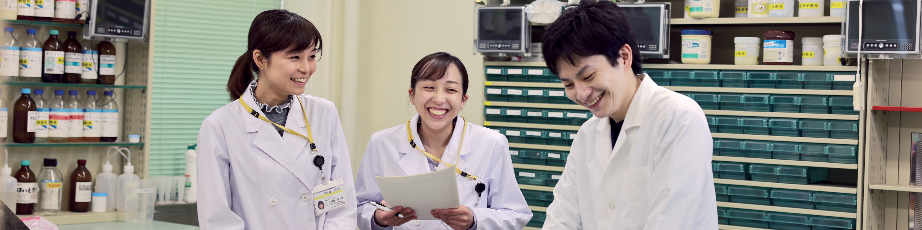 Three students in a lab at Showa University in Japan