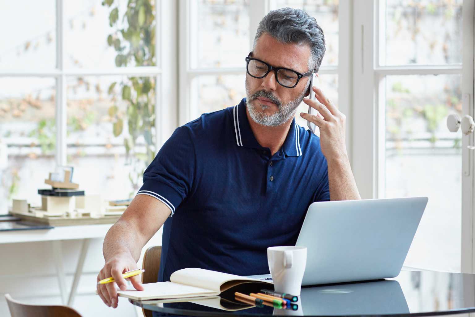 Mature man on laptop and phone