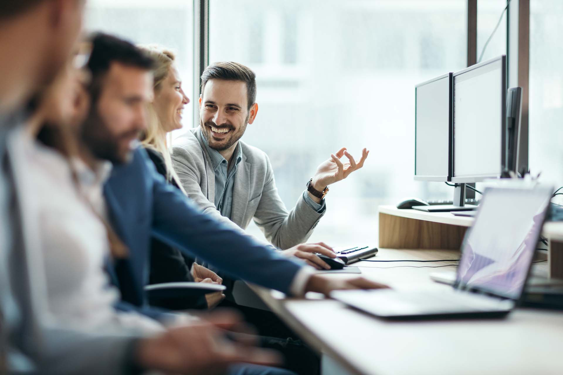 People talking in front of a computer