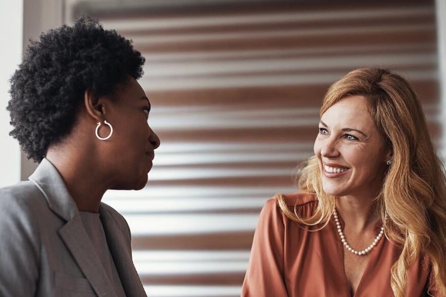 two women in a meeting talking about debtor status